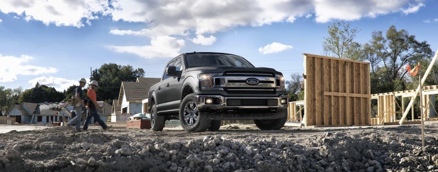 A grey 2018 Ford F-150 is shown parked at a construction site.