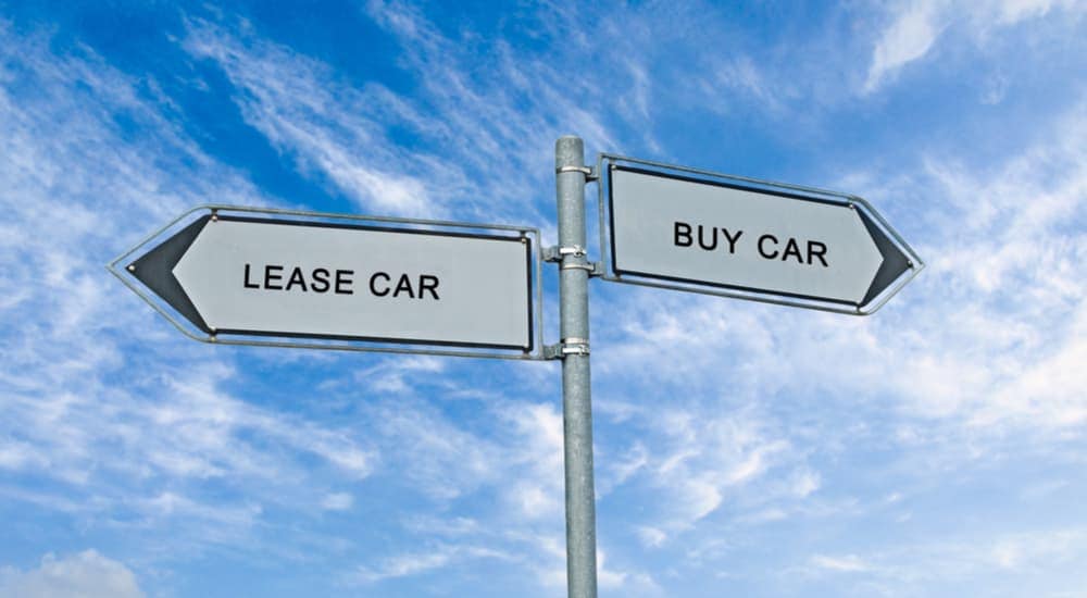 Lease car and buy car signs on a post