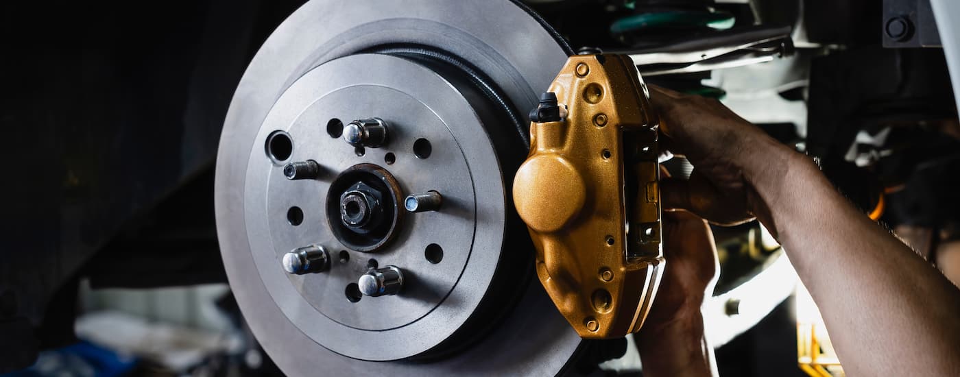 A mechanic is working on a set of brakes during a brake service in Charlotte.