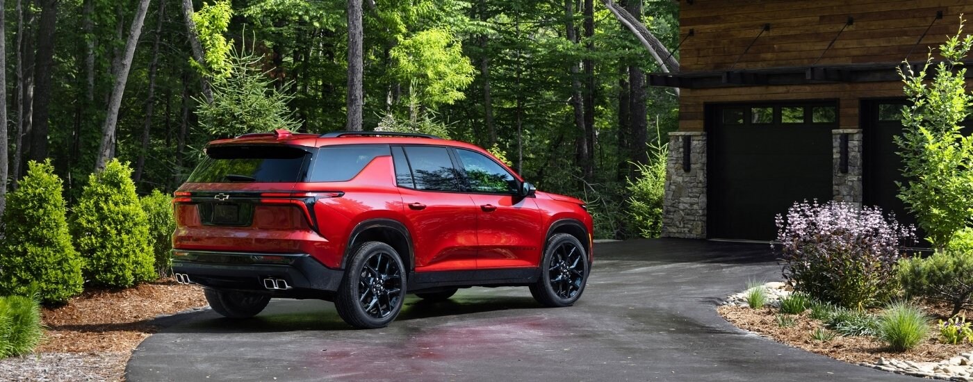 A red 2025 Chevy Traverse from the side after leaving a car dealer near Matthews.