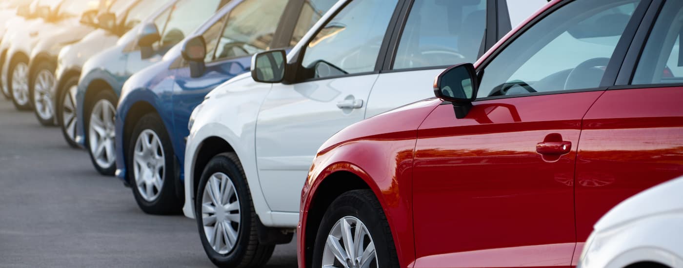 A row of colorful cars at a Charleston car dealership.