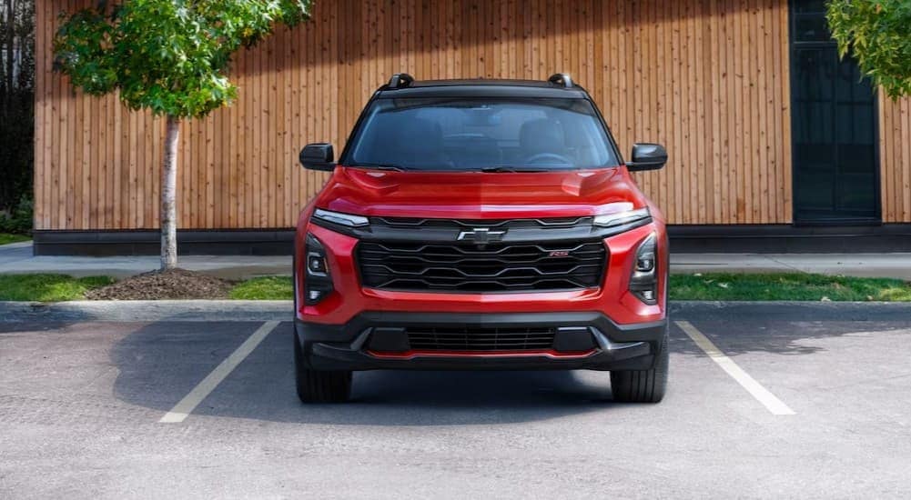 A red 2025 Chevy Equinox RS is shown parked on a sunny day.