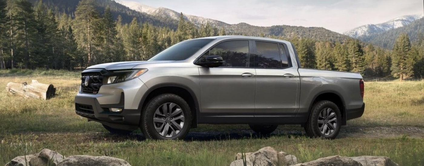 Trucks%20for%20Sale%20Near%20Wake%20Forest%20-%202025%20Honda%20Ridgeline%20Sport%20-%20Field.jpg Silver 2025 Honda Ridgeline Sport parked off-road
