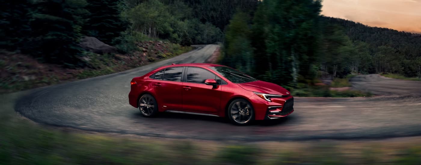 Cars%20for%20Sale%20Near%20Mount%20Pleasant%202025%20Toyota%20Corolla%20SE%20AWD%20Hybrid%20-%20Red%20Winding%20Road.jpg Red 2025 Toyota Corolla SE leaving a dealer with cars for sale near Mount Pleasant