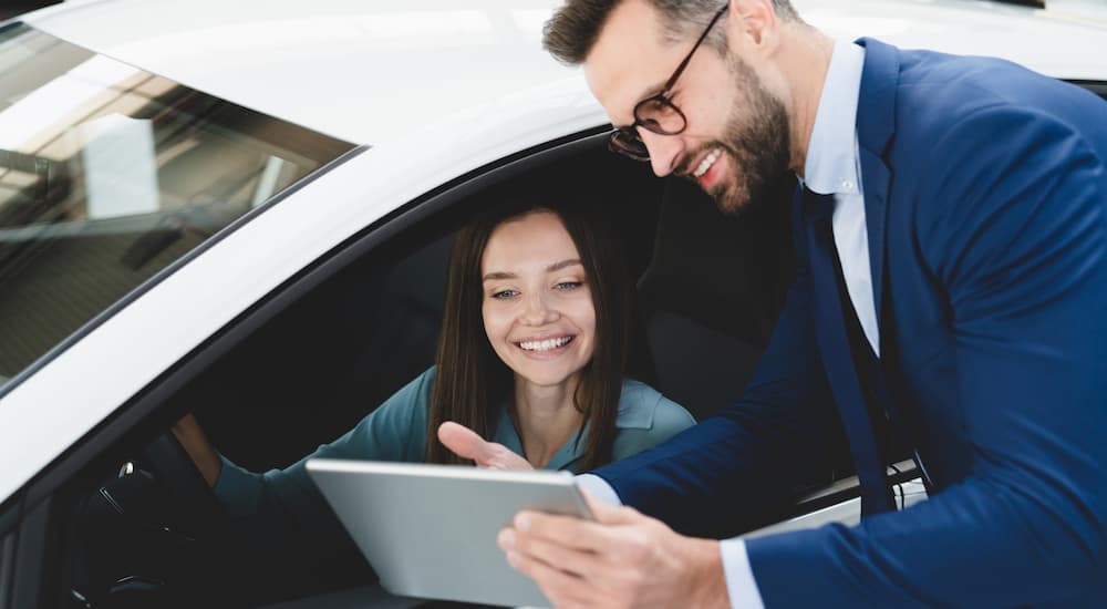 Salesman and customer talking about car financing