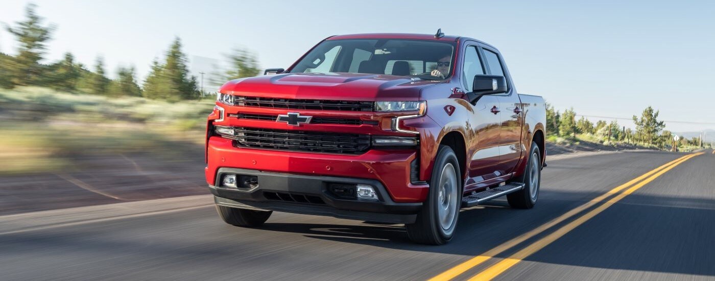 Red 2020 Chevy Silverado 1500 Z71 driving to a dealer with trucks for sale near Durham.