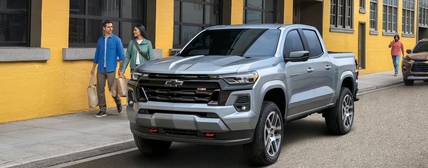 Truck%20Dealership%20Near%20Raleigh%20-%202023%20Chevy%20Colorado%20Z71%20-%20Silver%20Side%20Street.jpg A silver 2024 Chevy Colorado Z71 is parked on the side of a city street.