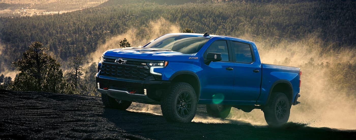 Trucks%20for%20Sale%20Near%20Wake%20Forest%20-%202025%20Chevy%20Silverado%201500%20ZR2%20-%20Blue%20copy%202.jpg Blue 2025 Chevy Silverado 1500 ZR2 driving to look at trucks for sale Near Wake Forest
