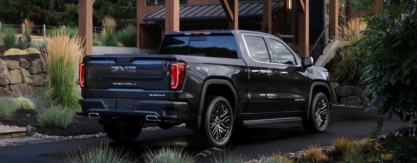 A black 2024 GMC Sierra 1500 from the rear at an angle.