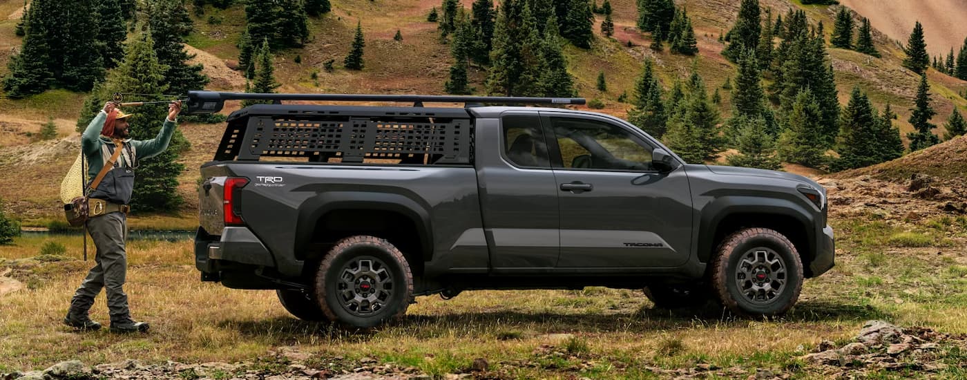 Trucks%20for%20Sale%20Near%20Sandy%20Springs%202025%20Toyota%20Tacoma%20PreRunner%20-%20Side.jpg Black 2025 Toyota Tacoma PreRunner parked on a grassy trail